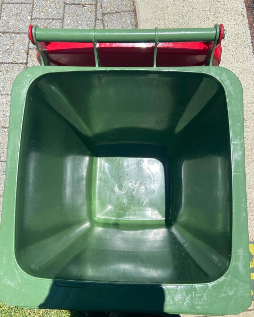 Green and red colored open dustbin ready to use for trash in Bin Cleaning Perth