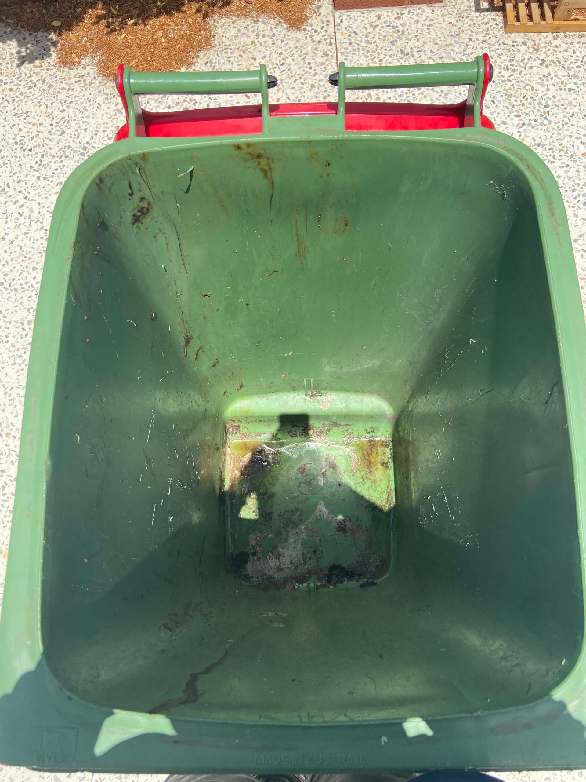 Green and red colored open dirty dustbin in Bin Cleaning Perth